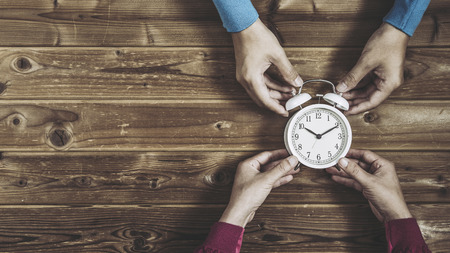 man and woman have watch on wood tableの写真素材