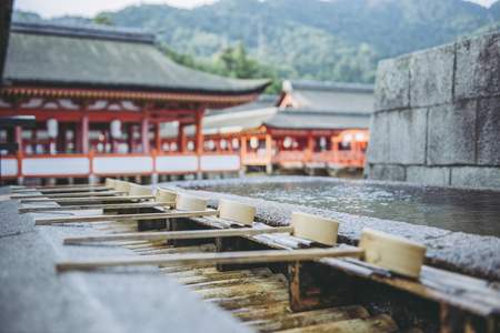 Hiroshima,Japan - July 26,2018 - Miyajima is a small island of Hiroshima in Japan. It is most famous for its giant torii gate, which at high tide seems to float on the water.のeditorial素材