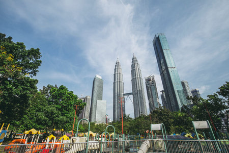Kuala Lumpur, Malaysia -  May 14,2018 - Petronas Towers and KLCC.Petronas Towers is a high-rise...