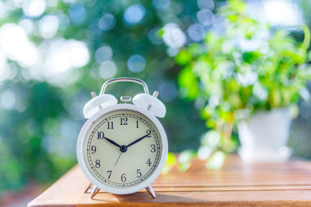 Green blur background and alarm clock