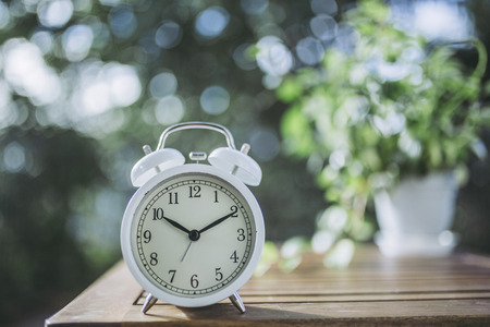 Green blur background and alarm clockの写真素材