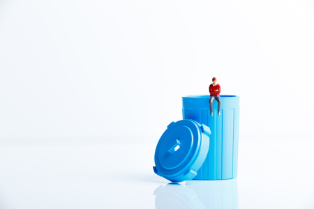 Trash can and miniature peopleの写真素材