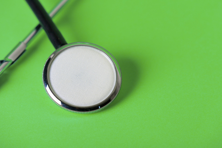 Green background and stethoscopeの写真素材