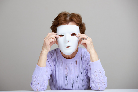 Senior female with white maskの写真素材