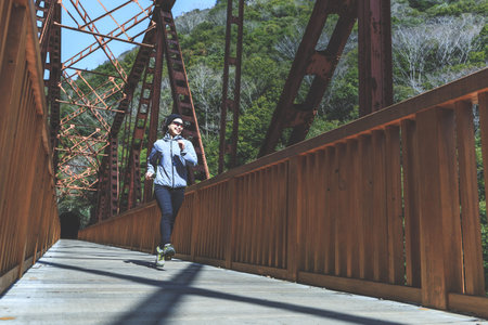 Asian lady running on the iron bridge