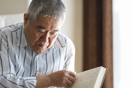 senior male reading bookの写真素材