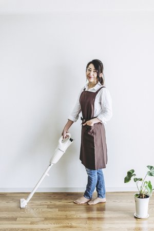 Vacuum cleaner and Japanese womenの写真素材