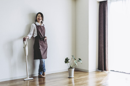 Vacuum cleaner and Japanese womenの写真素材