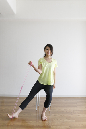 Asian women stretching in the roomの写真素材
