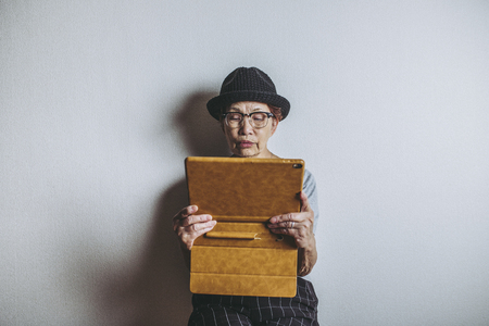 Tablet and older Asian womenの写真素材