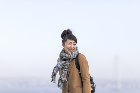 A woman wearing a coat and a mufflerの写真素材