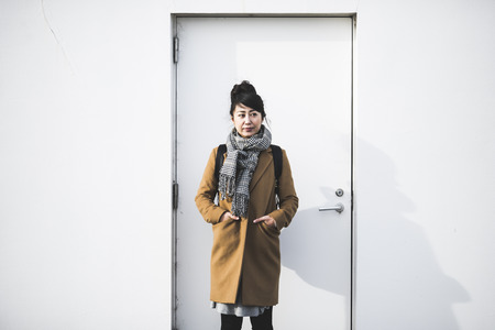 A woman wearing a coat and a mufflerの写真素材