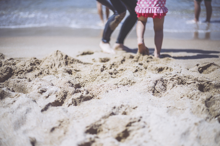 Sand beach and person's footの写真素材