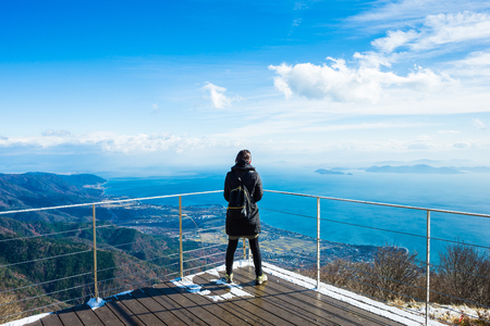 A woman looking at the lakeの写真素材