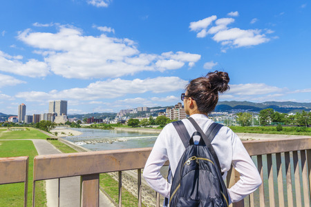 Blue sky and back of a womanの写真素材
