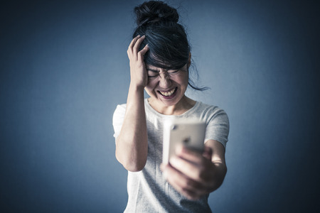 Female with trouble with smartphoneの写真素材