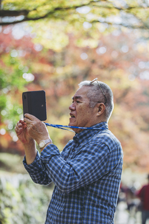 Elderly male and smartphoneの写真素材