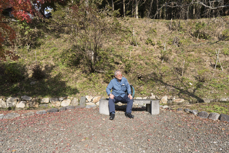 Elderly men sitting on the benchの写真素材
