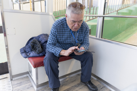 Mobile and elderly maleの写真素材