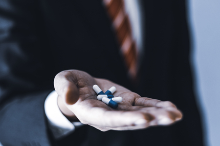 Businessman with medicineの写真素材