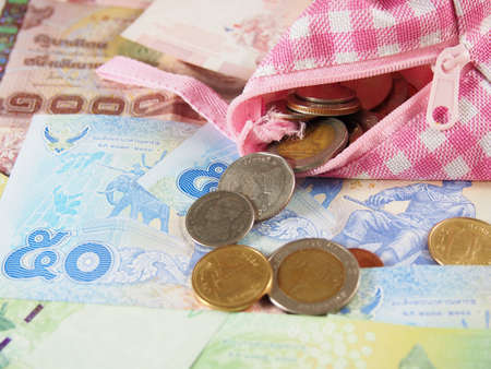 Spend Money with Purse on Banknotes of Thai Baht Backgroundの写真素材