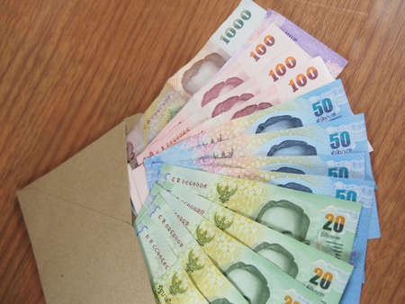 Thai Baht Money, arranged banknotes in brown envelope, soft focusの写真素材