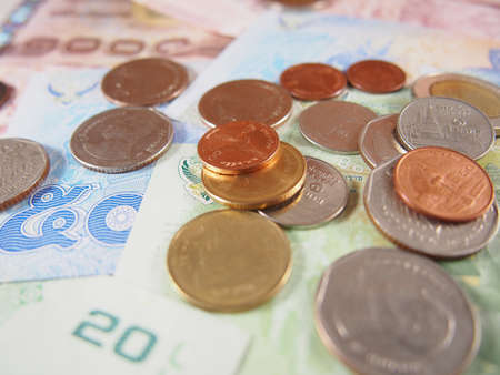 Coins on banknotes, thai baht money background, soft focusの写真素材