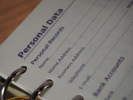 Opened notebook on personal data page, fill in data, name, address, telephone numberの写真素材