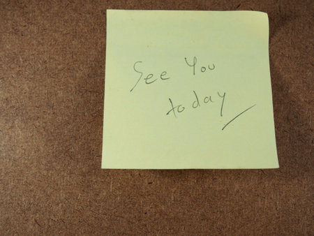 See you today, writing on yellow sticker paper, reminder on  brown board background