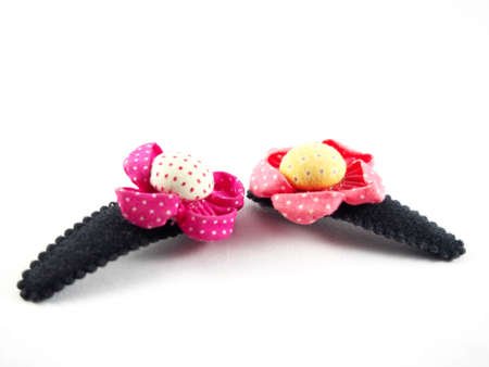 Handmade flowers, made from colorful fabric, sunflower shape on black hair clip, modern hair accessory, isolated on white backgroundの写真素材