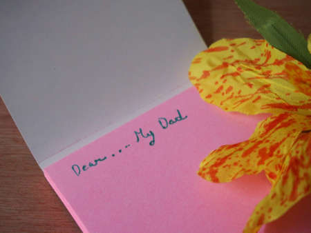 Dear my dad, note on pink paper with handmade canna flowerの写真素材