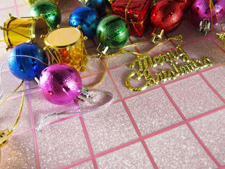 Multicolored Merry Christmas on pink tartan backgroundの写真素材