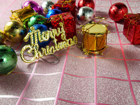 Merry Christmas, golden tag, multicolor christmas ornament on tartan backgroundの写真素材