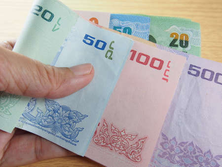 Taking banknotes in hand, saving and earn money, reward of the yearの写真素材