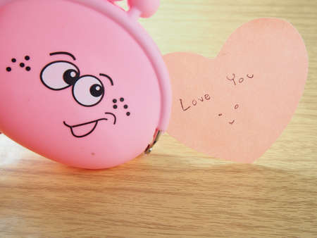 Sticky paper notes, love you word,  pink purse with smiling faceの写真素材