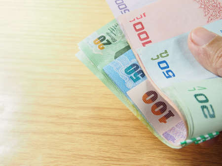 Economic finance, pile of Thai baht money in handの写真素材
