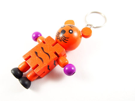 Orange kitty doll with key ring, handmade wood, isolated on white background