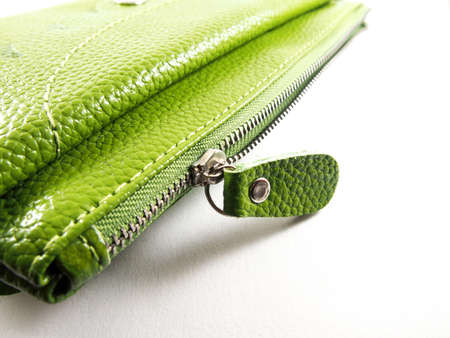 Handmade zipper on green leather purse, isolated on white backgroundの写真素材