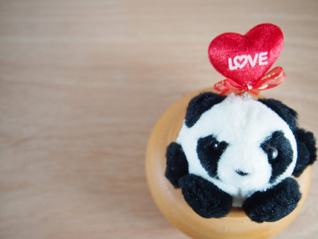 Round fat panda in baked clay jar, love on red heart pillow