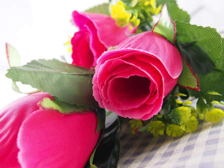 Pink rose flower, leafs of bouquet, made from plastic, fabric patternの写真素材