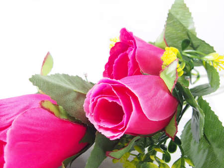 Pink rose flower, leafs of bouquet, made from plastic, fabric pattern on white backgroundの写真素材