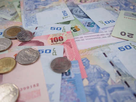 Earning money on saving account book with banknotes and coins background, finance status per month conceptの写真素材