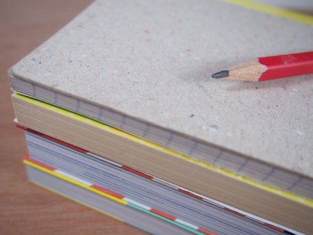 Black pencil on pile of book, reading and taking note concept