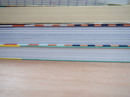 Stack of books spine on wooden table, prepare for reading
の写真素材