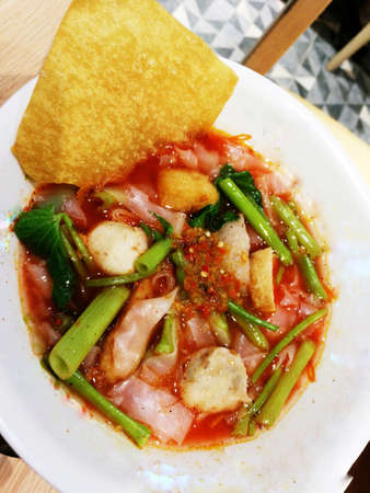 Noodle with red sauce soup on bowl, fastfood thai style
の写真素材