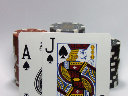 aces and jack of spades with chips