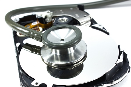 Computer hdd and hand with stethoscope - technology backgroundの写真素材