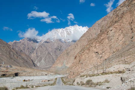 Street in China leading to a snow mountainの写真素材