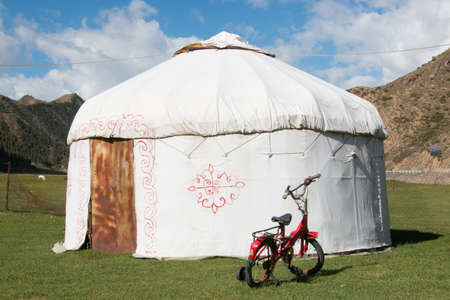 Red bike in front of a yurt in xinjiang Chinaのeditorial素材