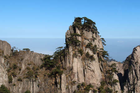 Huangshan mountain with single tree and blue sky in Chinaの写真素材